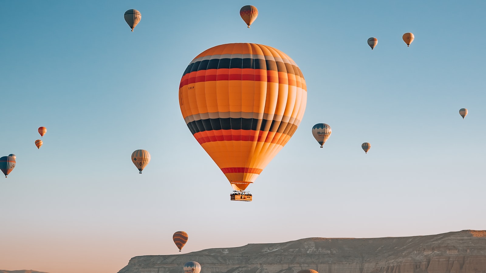 Hot air balloons flying over Cappadocia at sunrise, Turkey